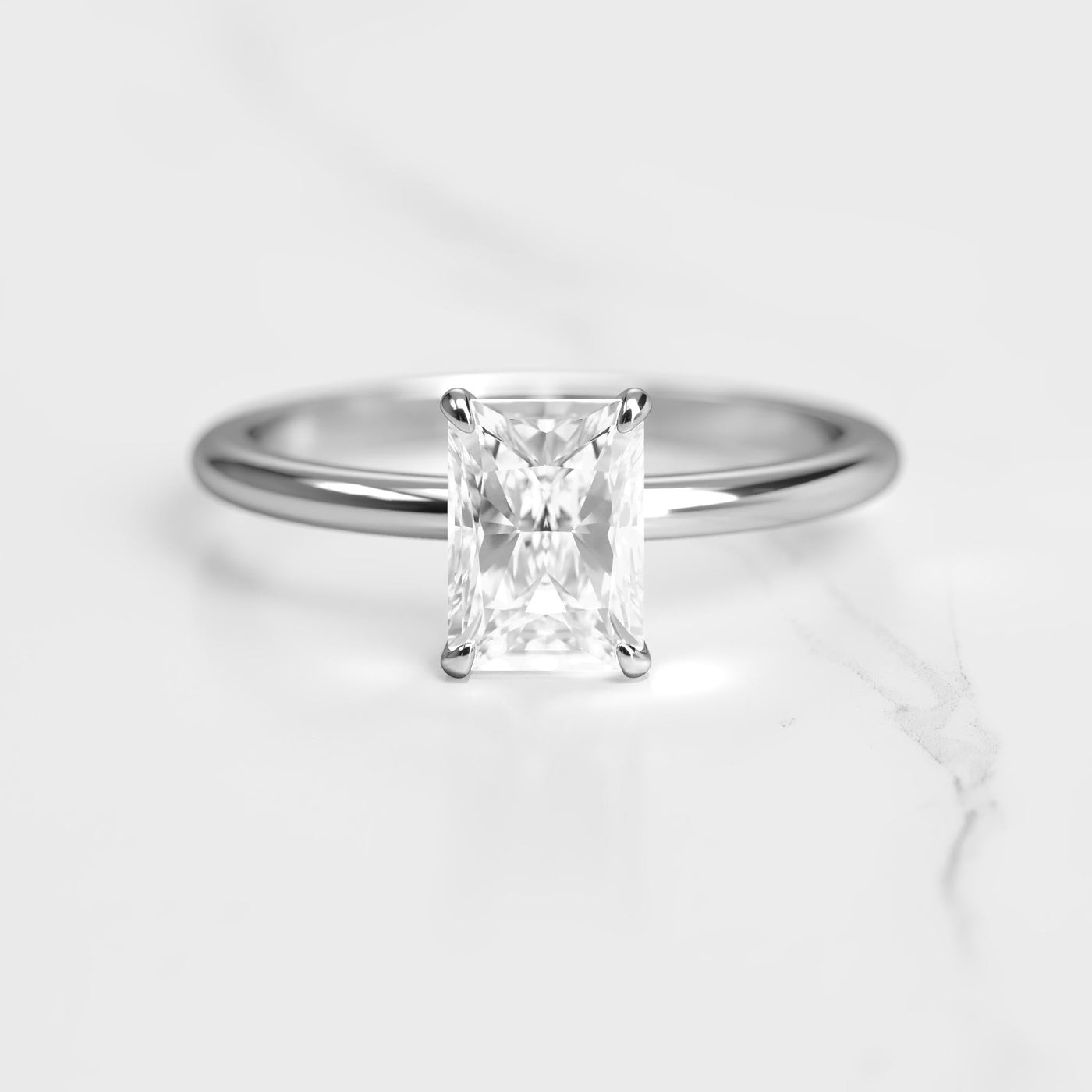 Radiant tapered solitaire moissanite ring