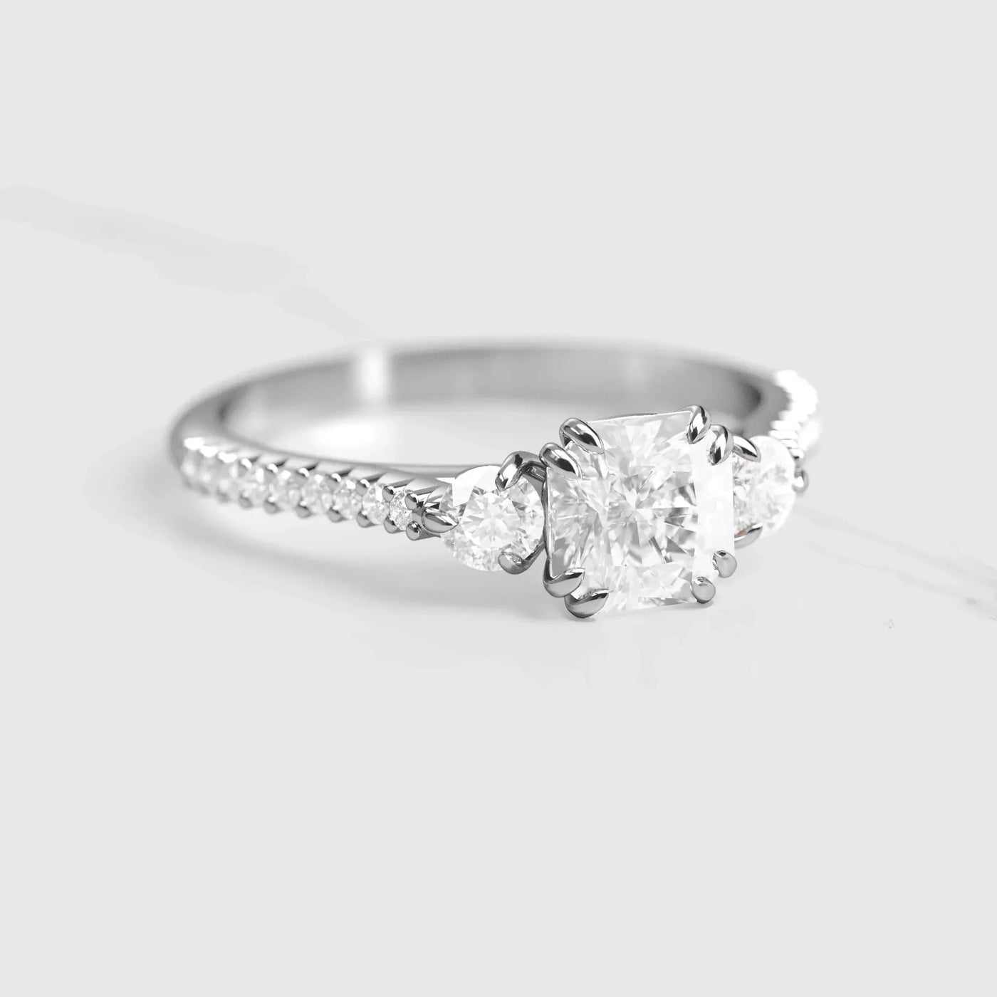 Gold engagement ring with Asscher cut lab white diamond and two round white lab diamonds on half pave eternity diamond ring