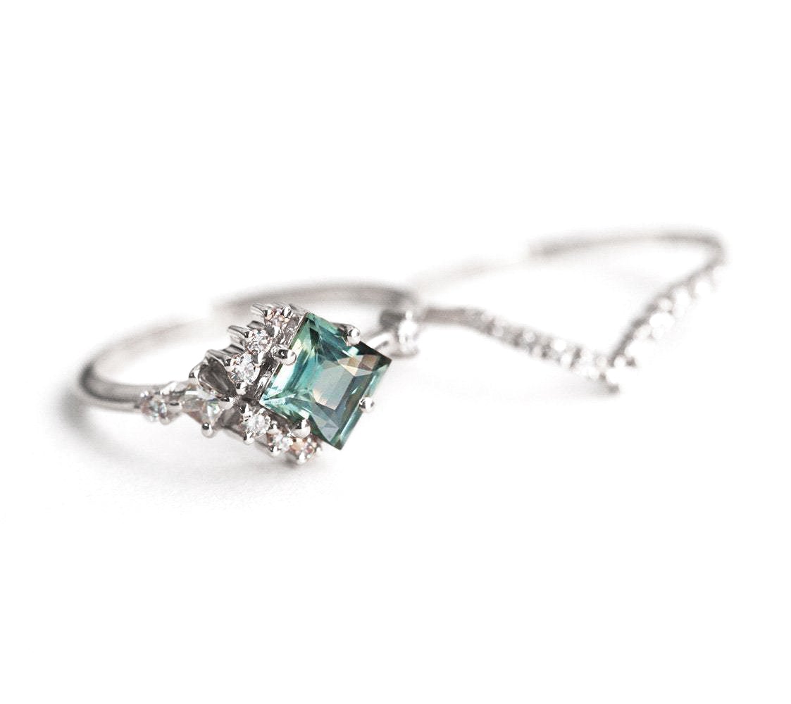 Mint-colored square sapphire with side diamonds and wedding band