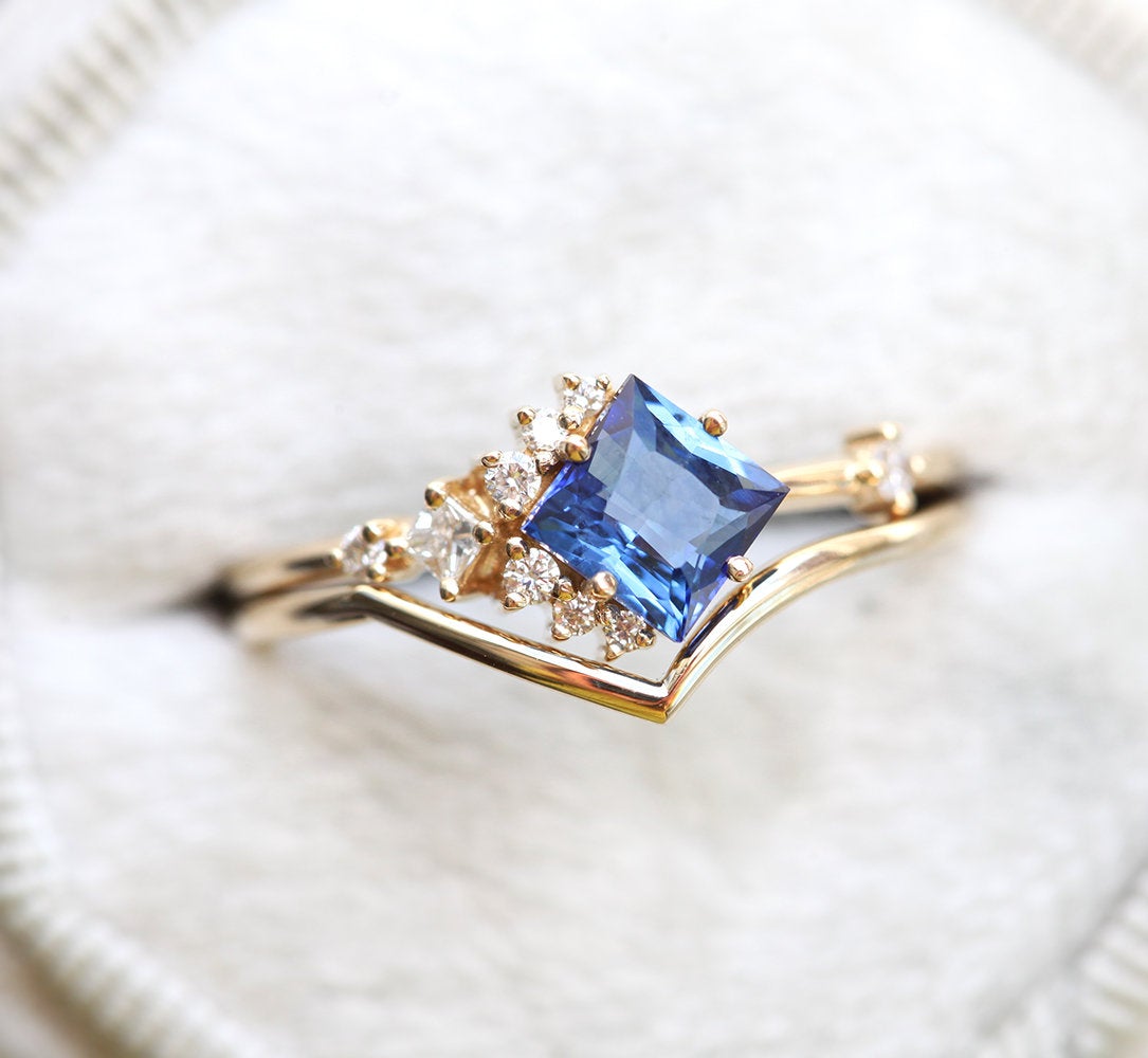 Princess-shaped sapphire ring with diamond cluster
