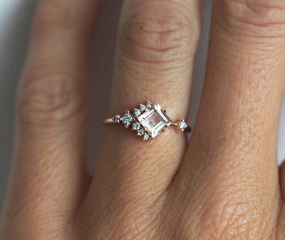 Square-shaped white sapphire ring with diamond cluster