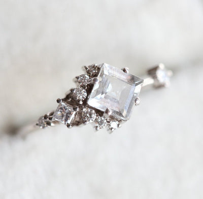 Square-shaped white sapphire ring with diamond cluster