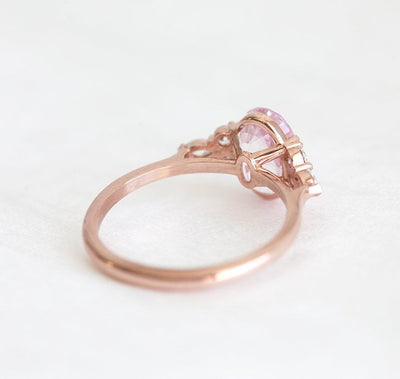 Oval-shaped peach sapphire ring with side diamonds