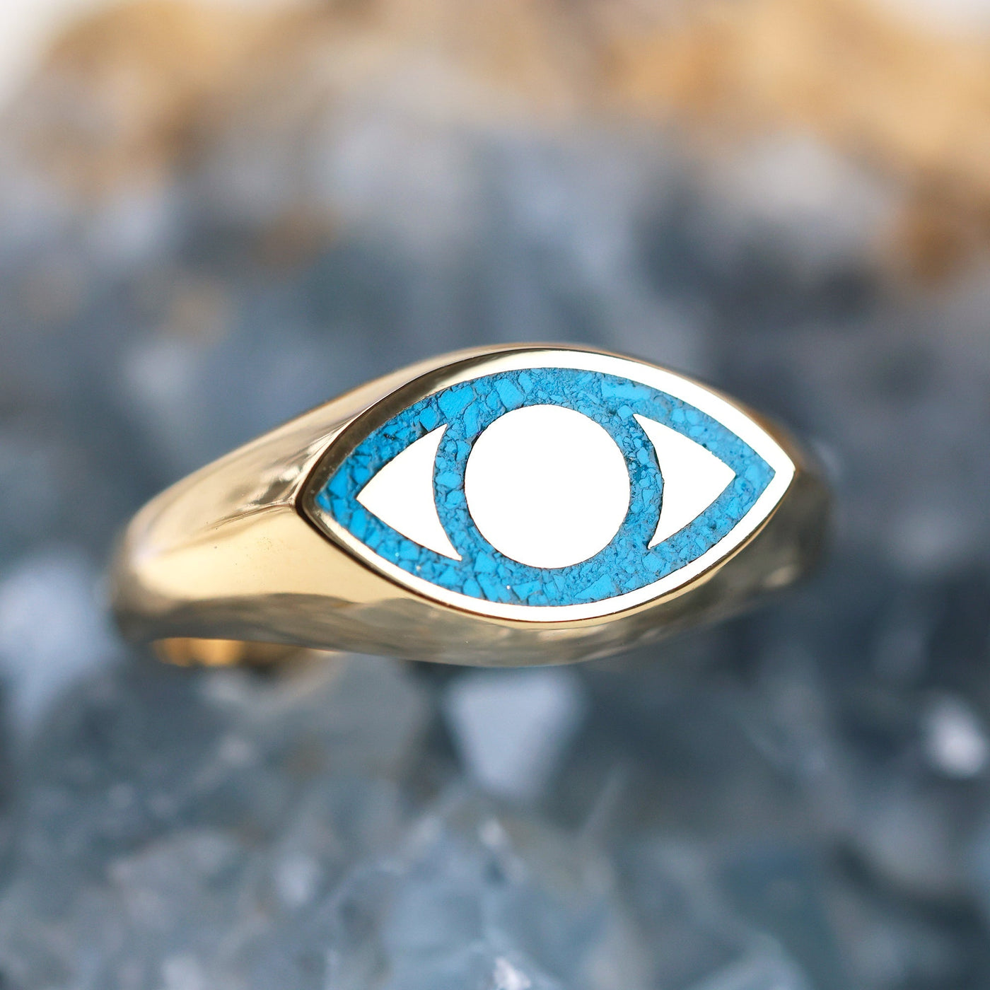 Gold signet ring with turquoise inlay, featuring a blue eye design. Unisex, polished finish, customizable gemstones. Made of 14k or 18k gold, platinum options. Band width 8mm front, 2.7mm back.