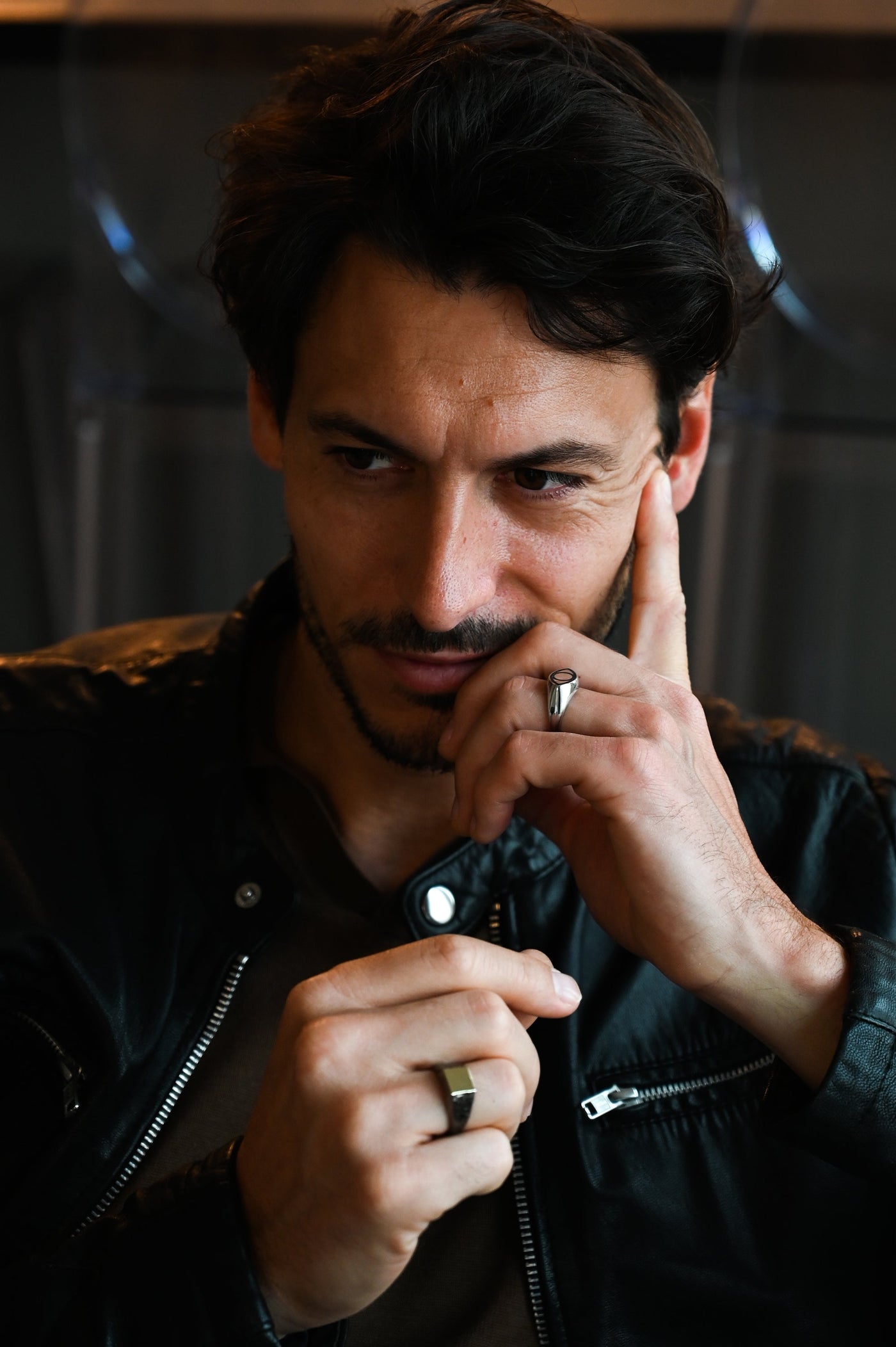 A man, showcasing the All Seeing Eye black spinel inlay signet ring.