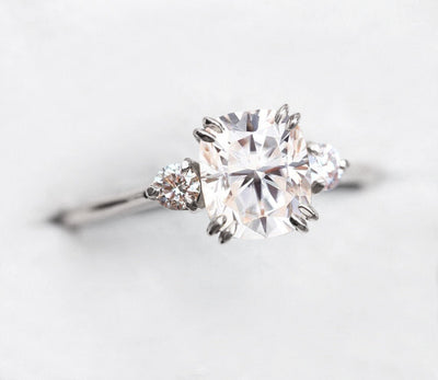 White cushion-shaped diamond ring with side diamonds