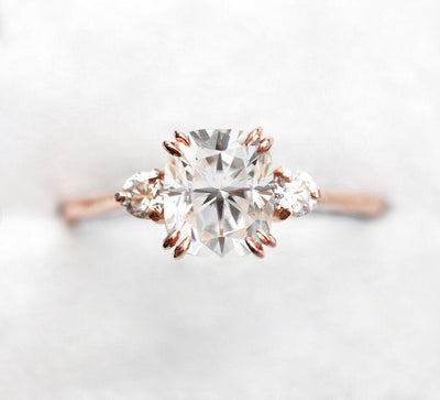 White cushion-shaped diamond ring with side diamonds