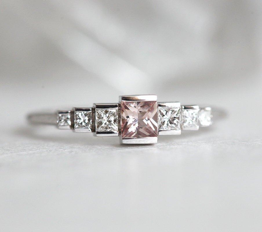 Princess-shaped pink sapphire ring with side diamonds