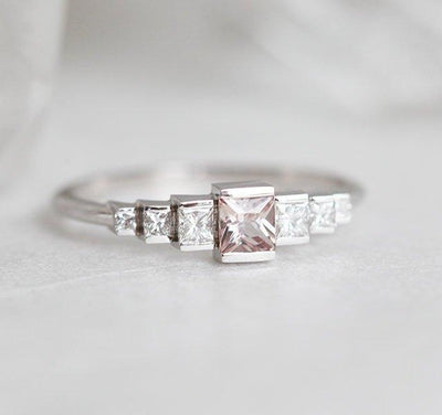 Princess-shaped pink sapphire ring with side diamonds