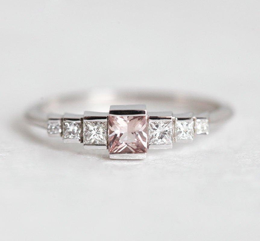Princess-shaped pink sapphire ring with side diamonds