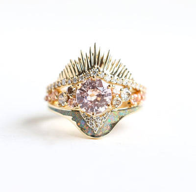 Round pink peach-colored sapphire ring with side diamonds