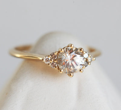 Round white sapphire ring with side diamonds