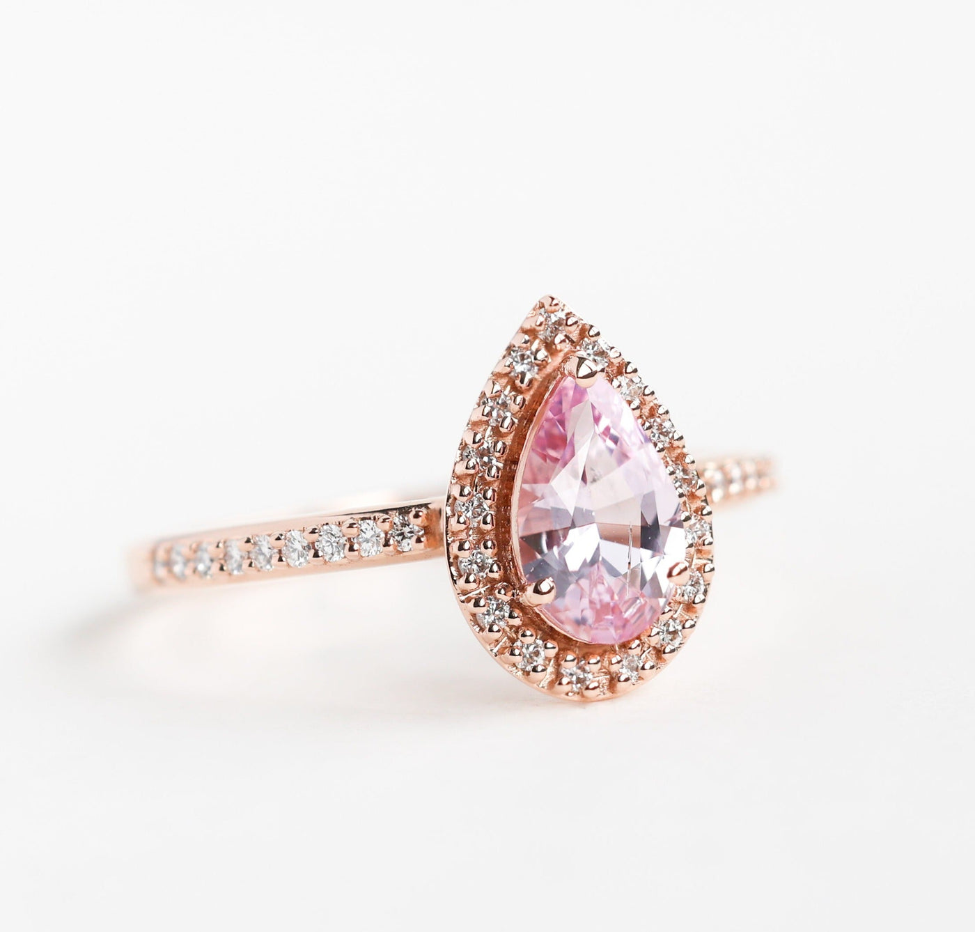 Pear-shaped pink ceylon sapphire ring with diamond halo