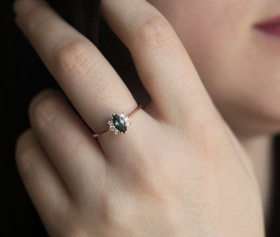 Green marquise-shaped sapphire ring with side diamonds