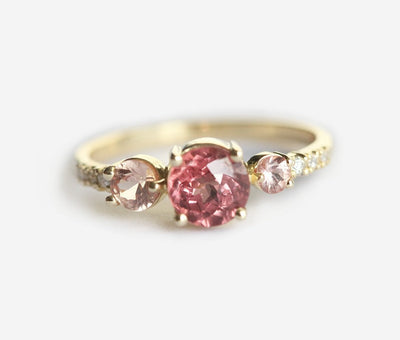 Round red garnet cluster ring with side diamonds and sapphires