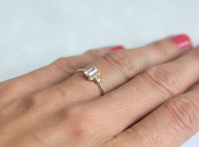 Baguette-shapped white sapphire cluster ring with side diamonds