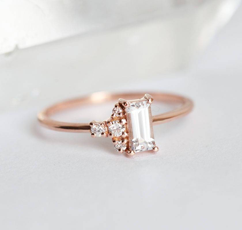 Baguette-shapped white sapphire cluster ring with side diamonds