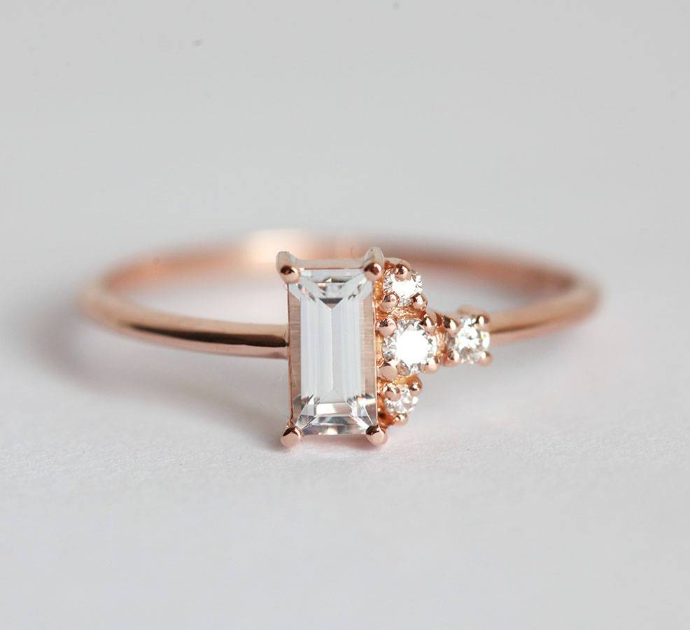 Baguette-shapped white sapphire cluster ring with side diamonds