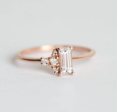 Baguette-shapped white sapphire cluster ring with side diamonds