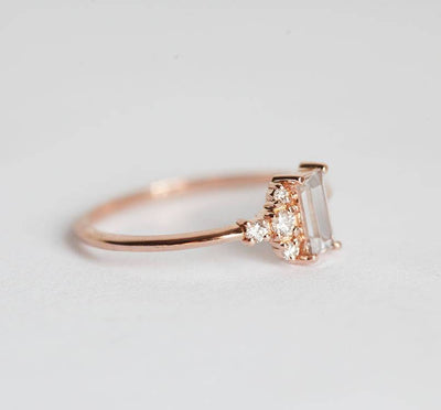 Baguette-shapped white sapphire cluster ring with side diamonds