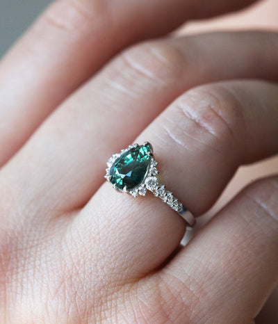 Pear-shaped teal sapphire ring with side diamonds
