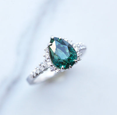 Pear-shaped teal sapphire ring with side diamonds