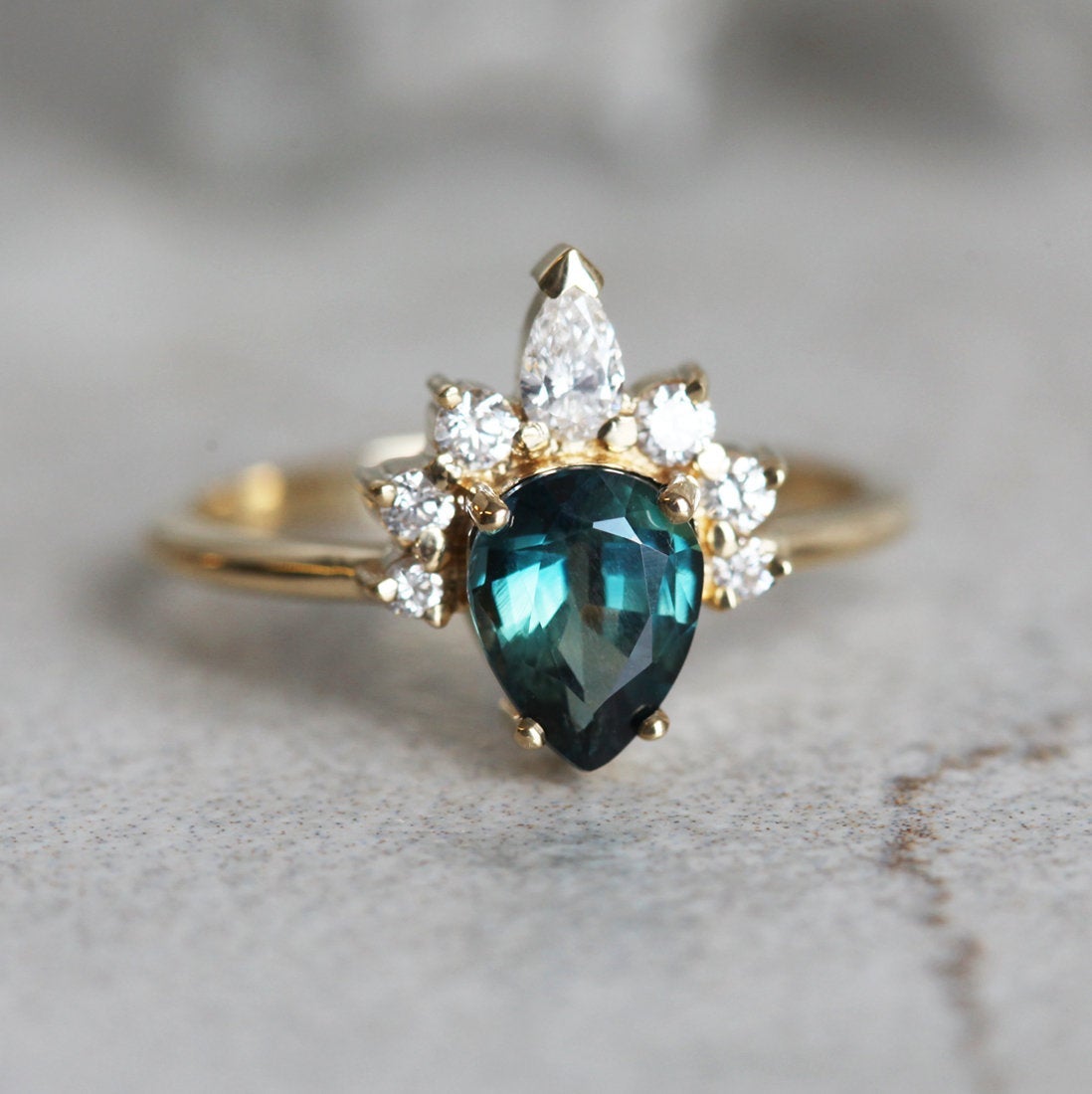 Pear-shaped teal sapphire ring diamond halo