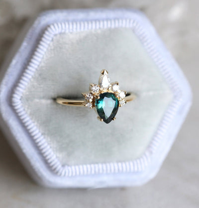 Pear-shaped teal sapphire ring diamond halo