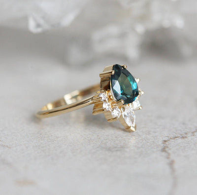 Pear-shaped teal sapphire ring diamond halo