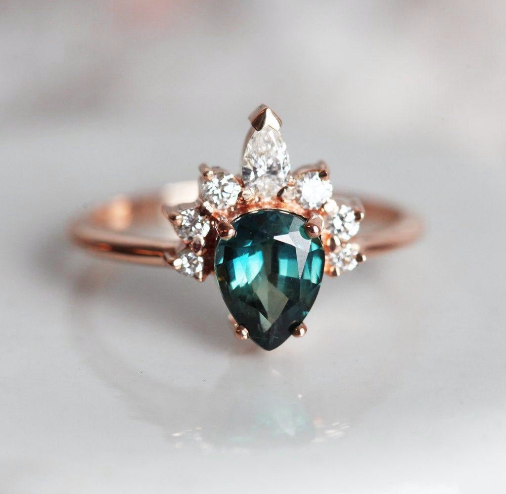 Pear-shaped teal sapphire ring diamond halo