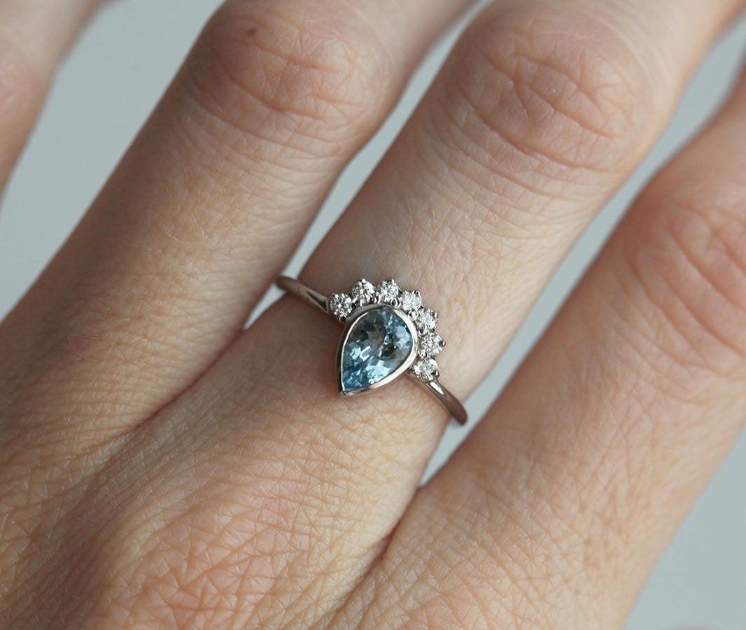 Pear Aquamarine Ring with Round White Diamonds forming a Halo
