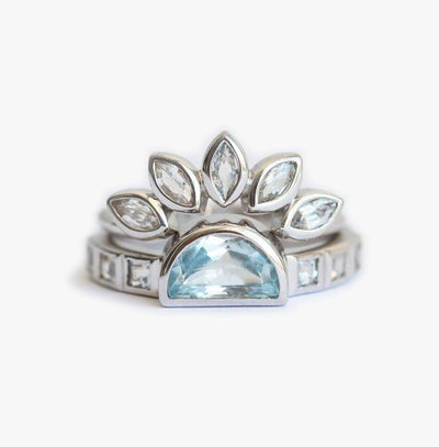 Half-moon-shaped blue aquamarine wedding ring with diamond and sapphire nesting