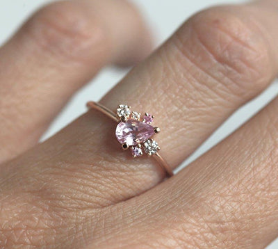 Pear-shaped pink sapphire ring with diamond cluster