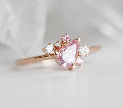 Pear-shaped pink sapphire ring with diamond cluster