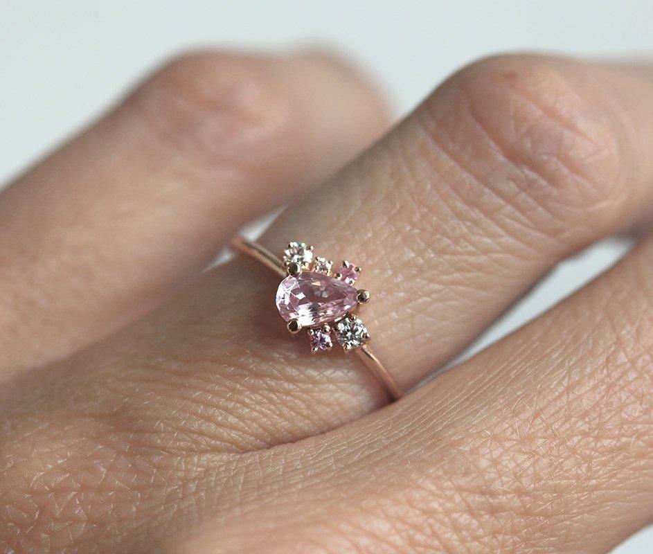 Pear-shaped pink sapphire ring with diamond cluster