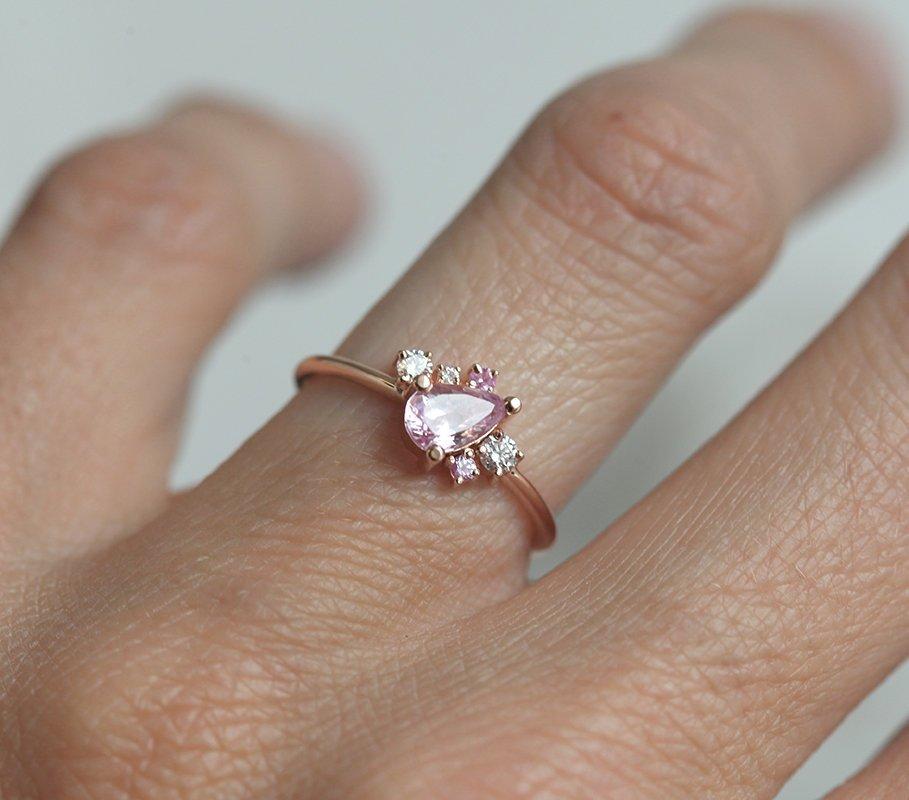 Pear-shaped pink sapphire ring with diamond cluster