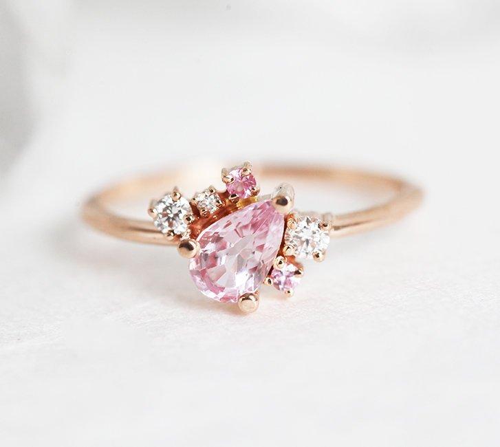 Pear-shaped pink sapphire ring with diamond cluster