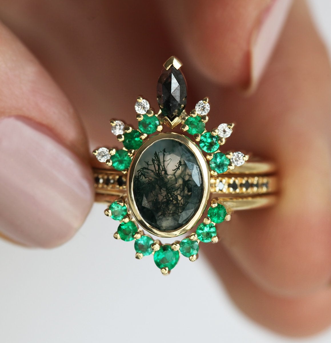 Oval Moss Agate Ring with Round Black Diamonds on the Band and Side Emeralds and White Diamonds