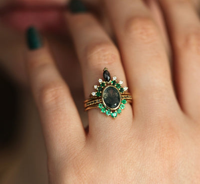 Oval Moss Agate Ring with Round Black Diamonds on the Band and Side Emeralds and White Diamonds