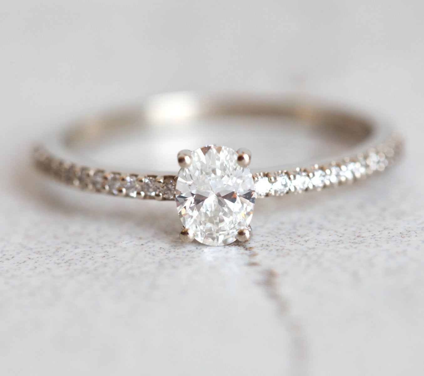 Oval White Diamond with half eternity pave diamond ring