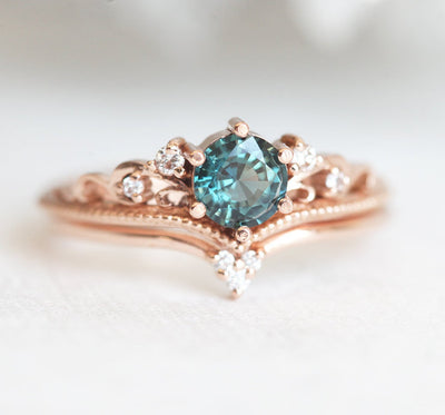 Round teal sapphire engagement ring with nested white diamonds