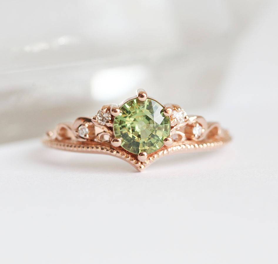 Round green sapphire ring with white side diamonds