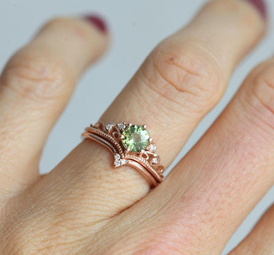 Round green sapphire ring with white side diamonds