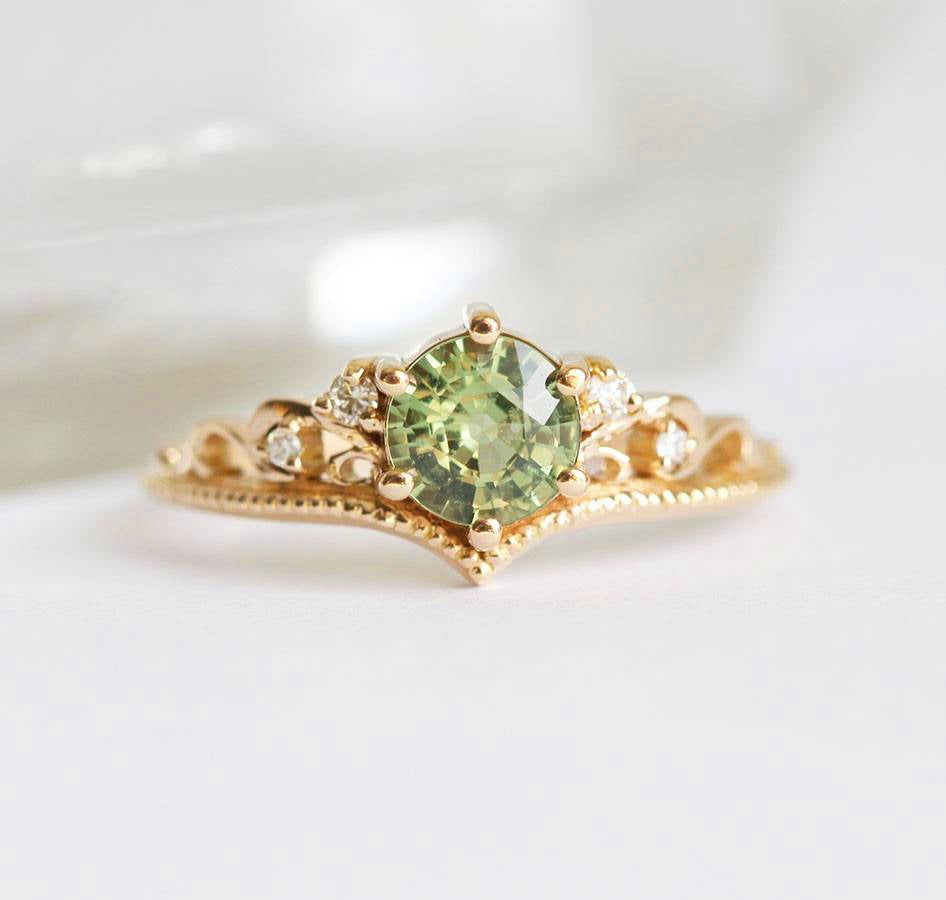 Round green sapphire ring with white side diamonds