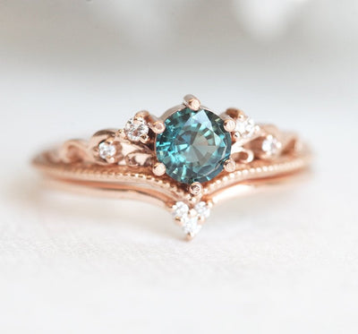 Round teal sapphire ring with white side diamonds