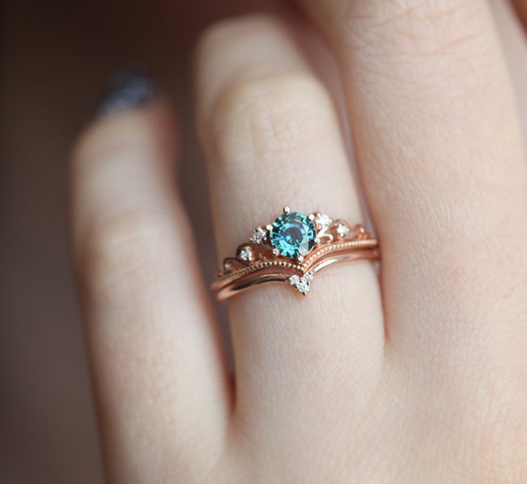 Round teal sapphire ring with white side diamonds