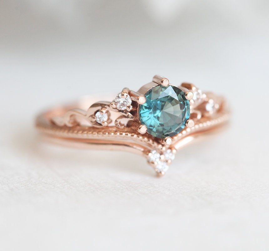 Round teal sapphire ring with white side diamonds