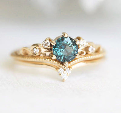 Round teal sapphire ring with white side diamonds