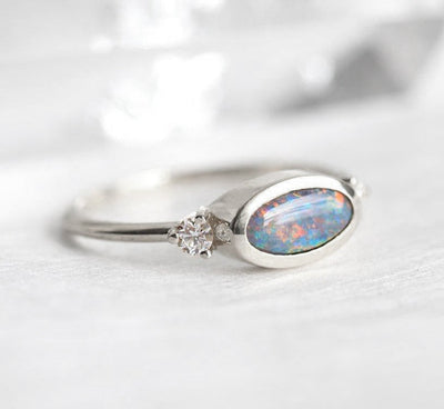 Three-Stone Oval Black Opal Ring with 2 Side White Diamonds