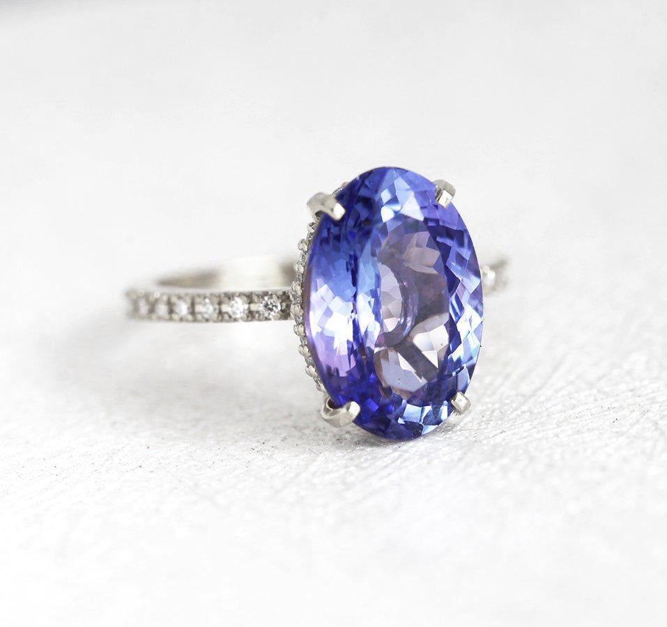 Purple Oval Tanzanite Platinum Ring with Round White Diamonds Nested in the Band